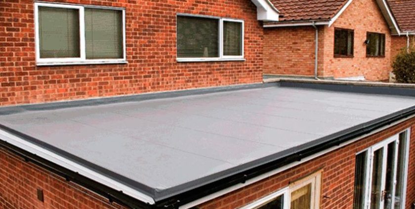 A flat roof with a brick wall and windows