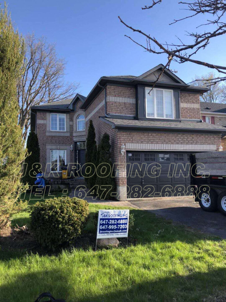 A large brick house with a truck parked in front of it.