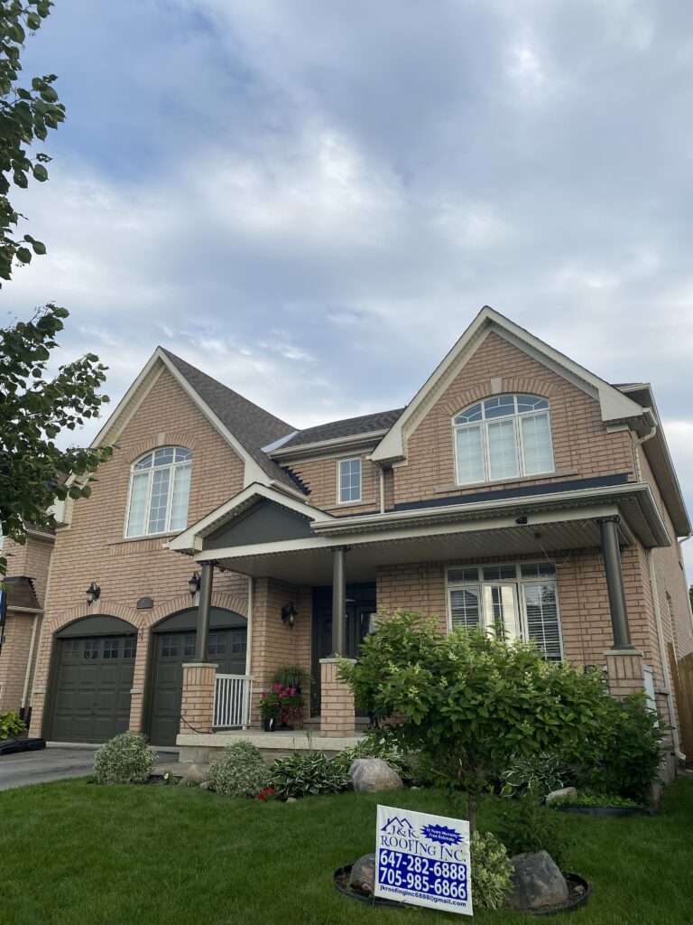 A large brick house with a garage and driveway.