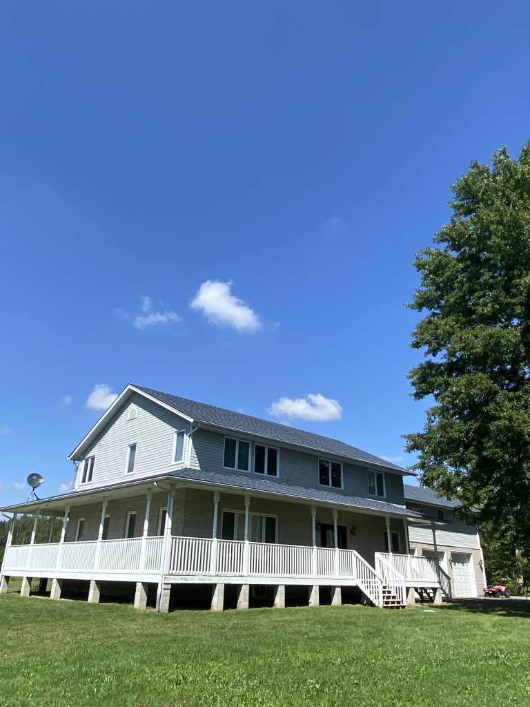 A large white house with steps leading to the front.