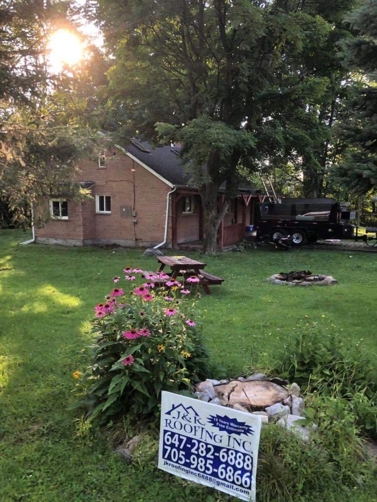 A house with a fire pit in the yard.