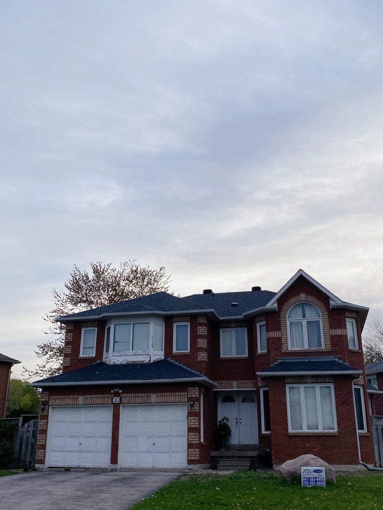 A large brick house with two garage doors.