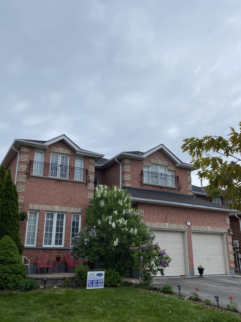 A large brick house with two garage doors.