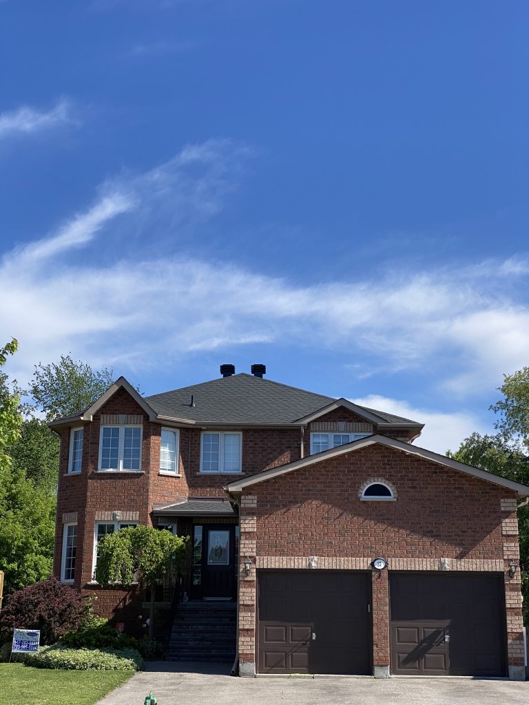 A large brick house with two garage doors.