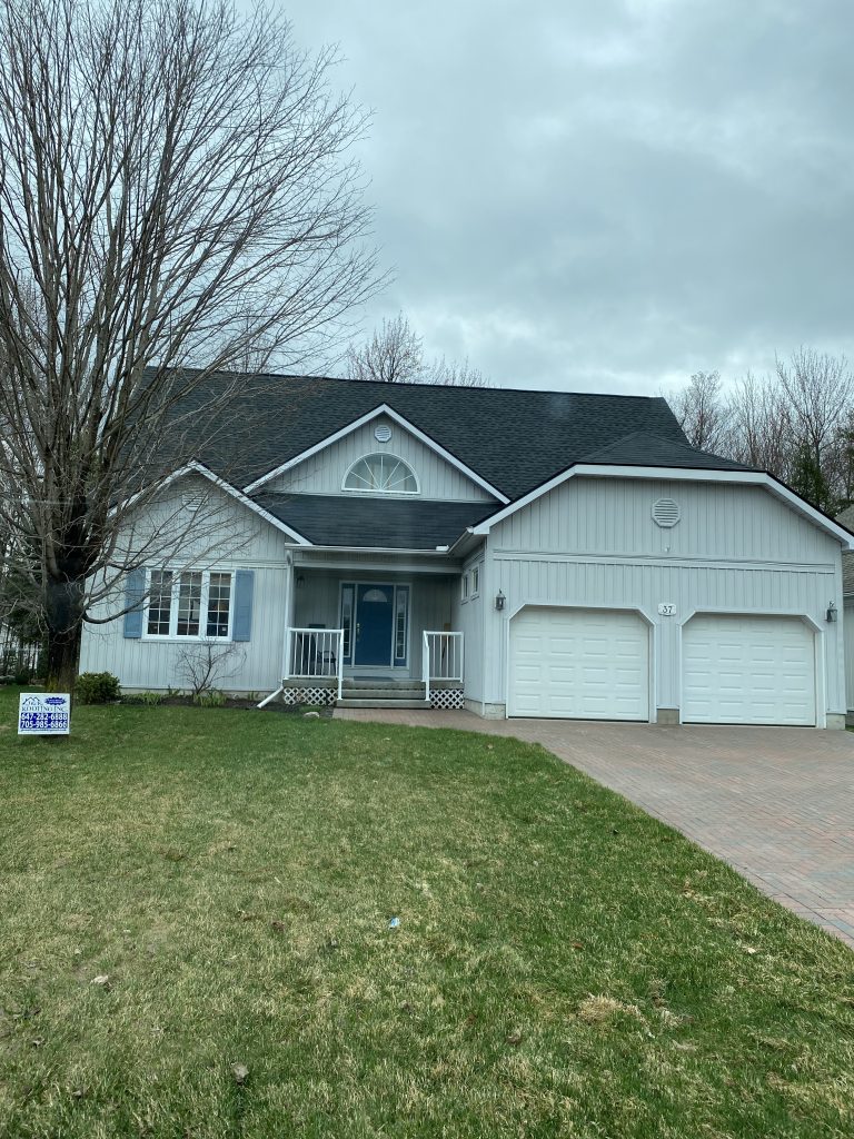 A house with two garage doors and a driveway.