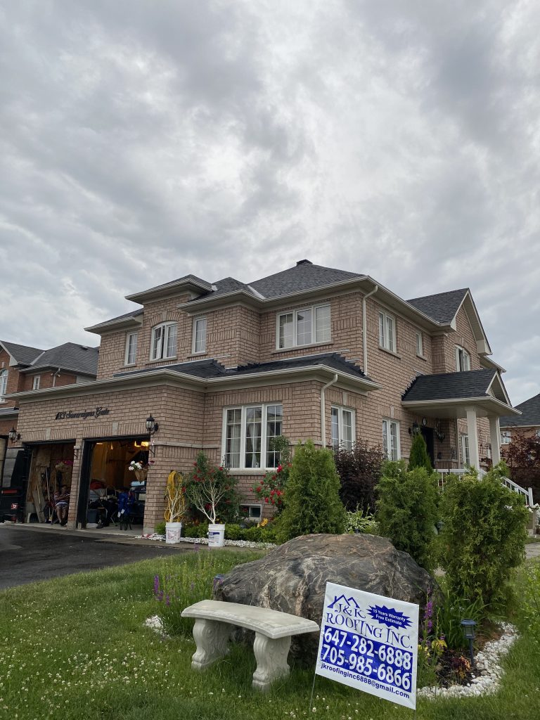 A large house with a garage in front of it.