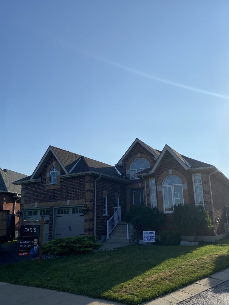 A large house with lots of windows and a garage.